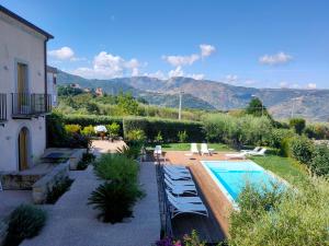 a garden with a swimming pool and a house at Alimunera in CastellʼUmberto