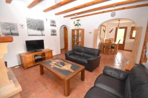 a living room with a couch and a table at Casa Delfin in Jávea