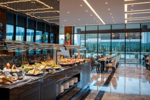 a buffet line with plates of food in a restaurant at Radisson Blu Hotel, Sakarya in Sakarya