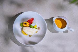 a plate of food and a cup of coffee at Hôtel & Restaurant Alain Llorca in La Colle-sur-Loup