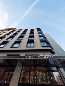 a tall building with a sign on the side of it at ARCELON HOTEL - From 2023 in Barcelona