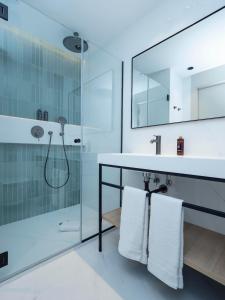 a bathroom with a glass shower and a sink at ARCELON HOTEL - 10 min walking to Sagrada Familia in Barcelona