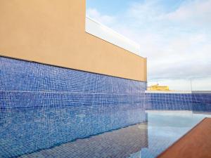 a swimming pool in front of a building at ARCELON HOTEL - From 2023 in Barcelona