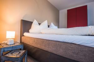 Un dormitorio con una cama con almohadas blancas. en Schwanensee Appartements, en Sommerach