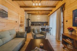 a living room with a couch and a table at Eco Village & Chalets Green Heaven in Mojkovac