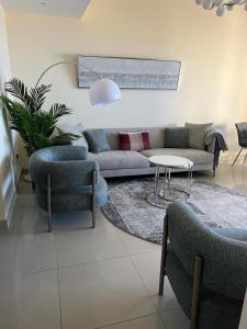a living room with a couch and chairs and a table at Royal Breeze view in Ras al Khaimah