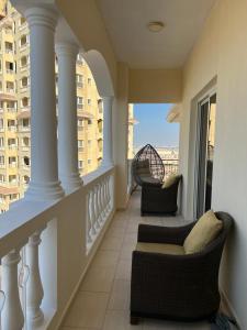 a balcony with two chairs and a view of a building at Royal Breeze view in Ras al Khaimah