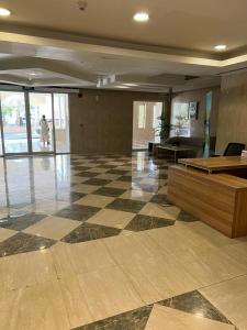 a lobby with a checkered floor in a building at Royal Breeze view in Ras al Khaimah
