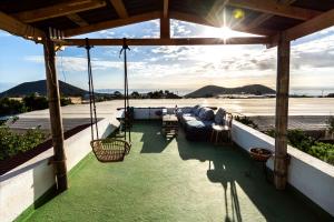 a porch with a couch and chairs on a patio at Los Conejos in Santa Cruz de Tenerife