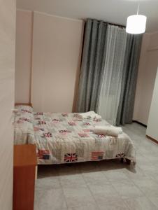 a bedroom with a bed with a blanket on it at Marino in Sassuolo