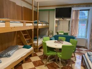 a room with bunk beds and a table and chairs at Viktoria in Vienna