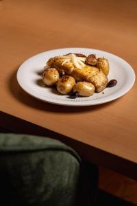 a plate of food on a wooden table at Villã - Casas de Campo in Paredes