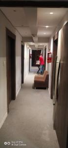 a man standing on a couch in a hallway at hotel shreenivas in Ahmedabad