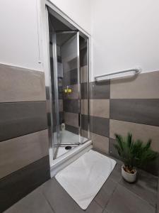 a bathroom with a shower with a glass door at George Street Rooms in Hull