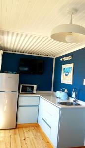 a kitchen with a white refrigerator and a sink at The Blue Room in Langebaan
