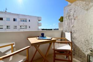 a small table and two chairs on a balcony at Agradable apartamento con terraza en Formentera in Es Pujols
