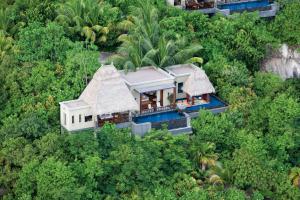 an aerial view of a house in the forest at Anantara Maia Seychelles Villas in Anse Boileau
