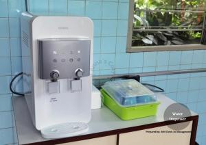a white appliance sitting on a counter in a bathroom at Jalan Kuhara 300 mbps BBQ spacious LR Detach Bungalow in Tawau