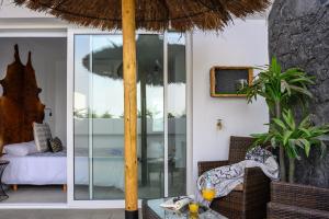 a patio with a table and an umbrella at Pachamama House-near the beach, fast wifi, air-con and SAT tv in Playa Blanca