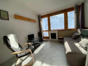 a living room with a couch and a chair at Studio pied des pistes La Mongie - Grand-Tourmalet in La Mongie