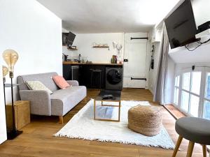 a living room with a couch and a table at Loft Varenne in Paris