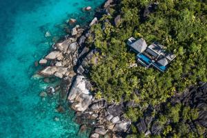 an aerial view of a house on a rocky island at Anantara Maia Seychelles Villas in Anse Boileau