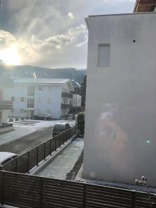 a white building with snow on the side of it at Appartamento nuovo e comfort a Brunico Kronplatz in Brunico