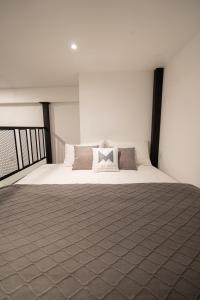 a bedroom with a large bed with white sheets and pillows at The Magazine Boutique Hotel in George Town +110 photos