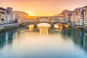 een brug over een rivier in een stad met gebouwen bij Duomo Central Studio in Florence