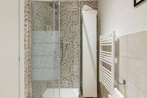 a shower with a glass door in a bathroom at Duomo Central Studio in Florence