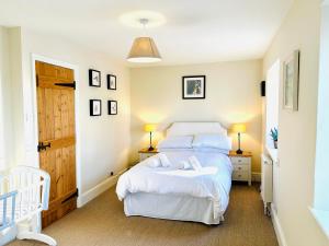 a bedroom with a bed with two towels on it at Beautiful Old Water Mill in Rural Herefordshire in Hereford