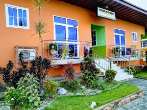 a colorful house with plants in front of it at Renajoe Exclusive Centre 