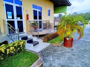 a house with a palm tree and flowers in front of it at Renajoe Exclusive Centre in Ahwiriso +27 photos