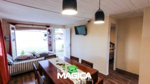 a dining room with a table and a couch at Quinta Aires in San Rafael