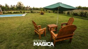 two chairs and an umbrella next to a pool at Quinta Aires in San Rafael +1 photo