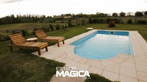 a patio with two chairs and a swimming pool at Quinta Aires in San Rafael