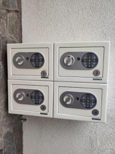 a group of four electrical switches on a wall at Ski Apartmán Sajmon so saunou in Makov