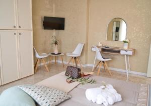 Cette chambre comprend un lit, des chaises et un miroir. dans l'établissement Lilium Apartment, Parco Velino Sirente, à Celano