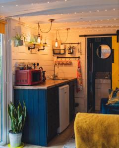 a kitchen with a red microwave on a counter at The Horrrsebox Tinyhouse Glamping in Garadice