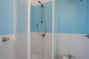 a bathroom with a shower with a tub and a toilet at Cielomare in Campofelice di Roccella +16 photos