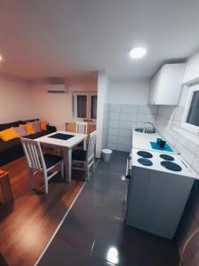 a kitchen with a table and a stove top oven at Apartmani Mir A1 in Vrnjačka Banja