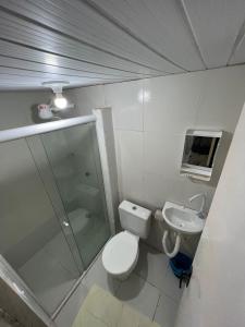 a small bathroom with a toilet and a sink at Pousada Mar do Sonho Praia in Ipojuca