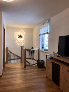 a living room with a flat screen tv next to a window at Bio Schartenhof in Sankt Johann im Pongau