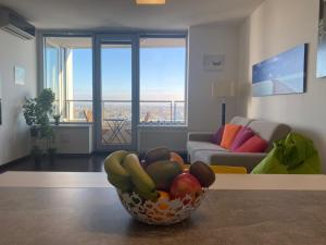 a bowl of fruit on a table in a living room at Fantastic view from the 20th floor in Bratislava