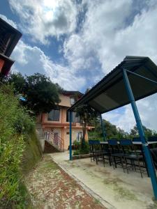 a picnic shelter in front of a house at Gombo Hideaway in Nagarkot