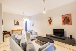 a living room with a couch and a tv at Xmajjar in Sliema