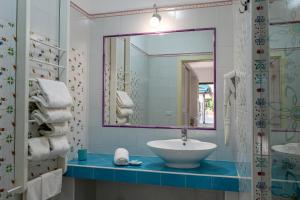 a bathroom with a sink and a mirror at Mia Resort Paestum in Paestum +14 photos