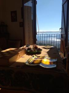 a table with food on it with a view of the ocean at Athena's Guest House in Stagiates