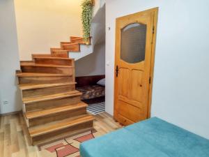 a stairway with a wooden door in a room at Villa Bella - A Rila Monastery Adventure in Kocherinovo