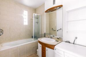 a bathroom with a sink and a shower and a tub at Marvellous Studio Paris 14 in Gentilly